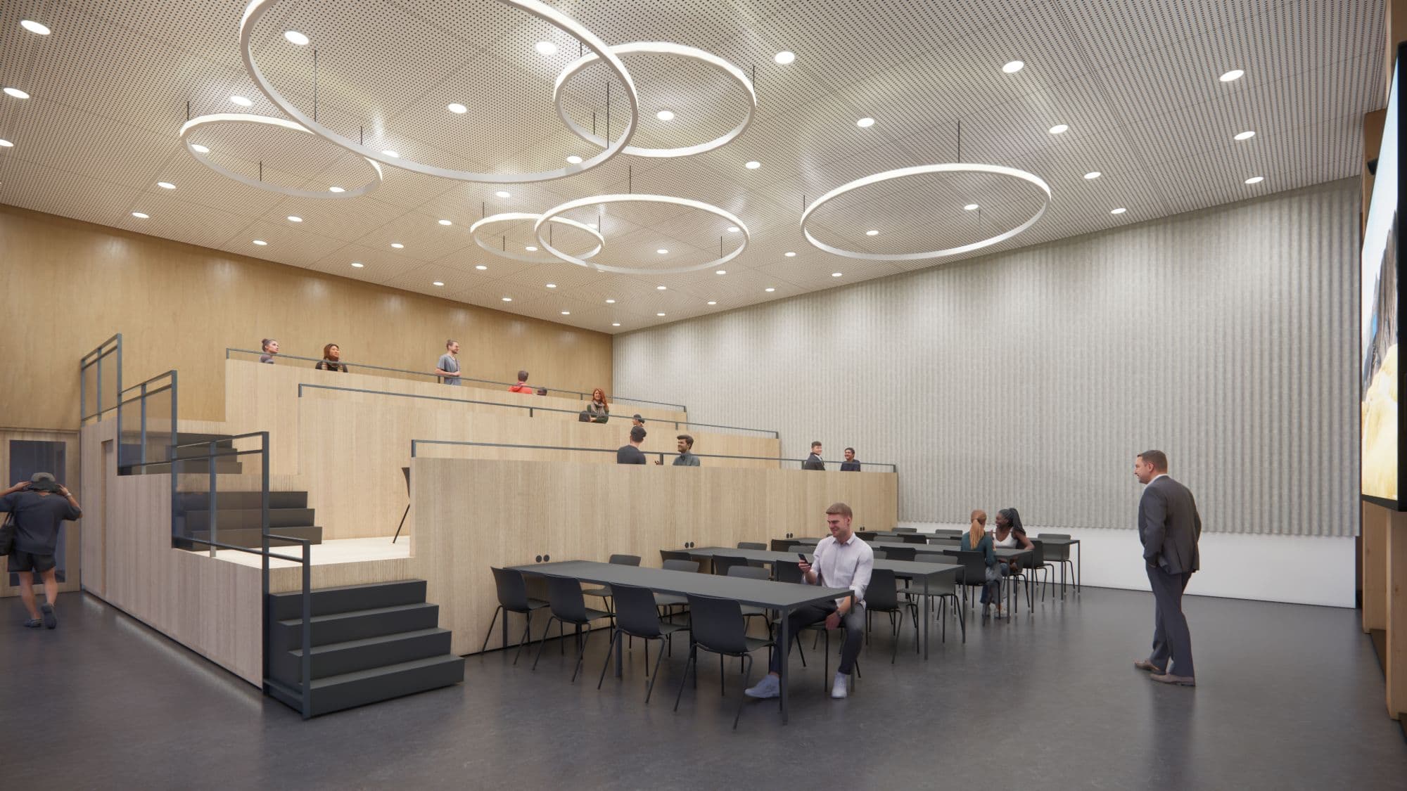 Werkgroepzaal met tribune, lange tafels en lichtringen, zakelijk project